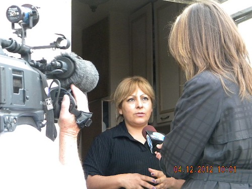 A woman is interviewed by a news crew